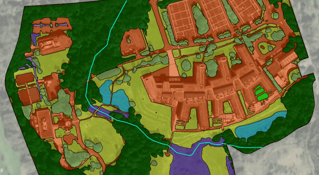 A color-coded habitat classification map overlaid on satellite imagery, showing a mix of developed land (in red), grassland, woodland, and ponds. Residential buildings and infrastructure dominate the central area, while green and natural habitats surround the development.